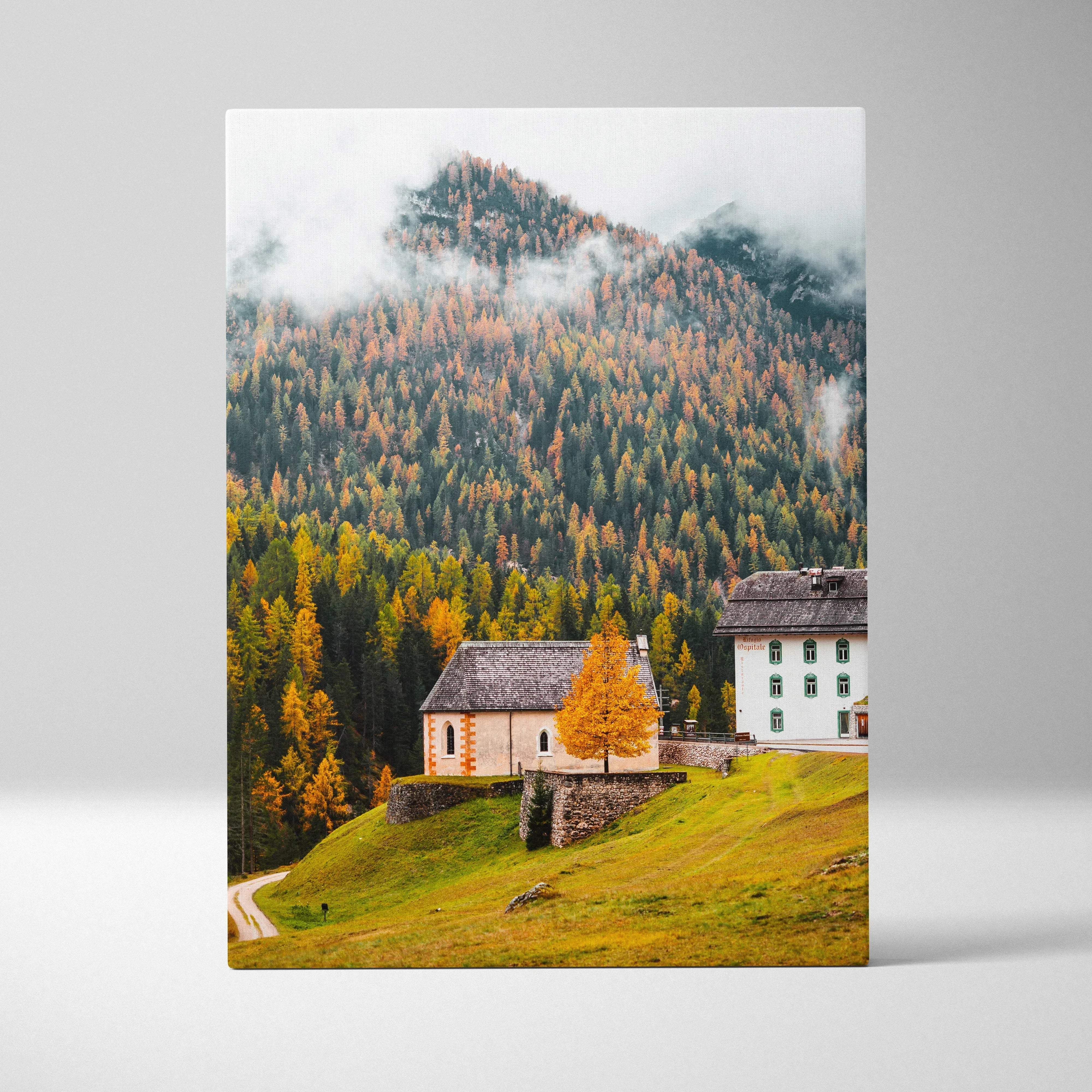 A rectangular canvas print of autumn alpine village with forested mountains misty peaks and rustic warm mood