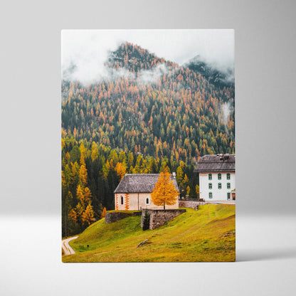 Canvas wall art featuring a serene mountain landscape with autumn-colored trees and rustic buildings.