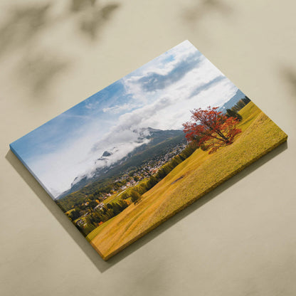 Canvas art depicting autumn mountains with fiery red and orange foliage under a blue sky, vibrant wall art.