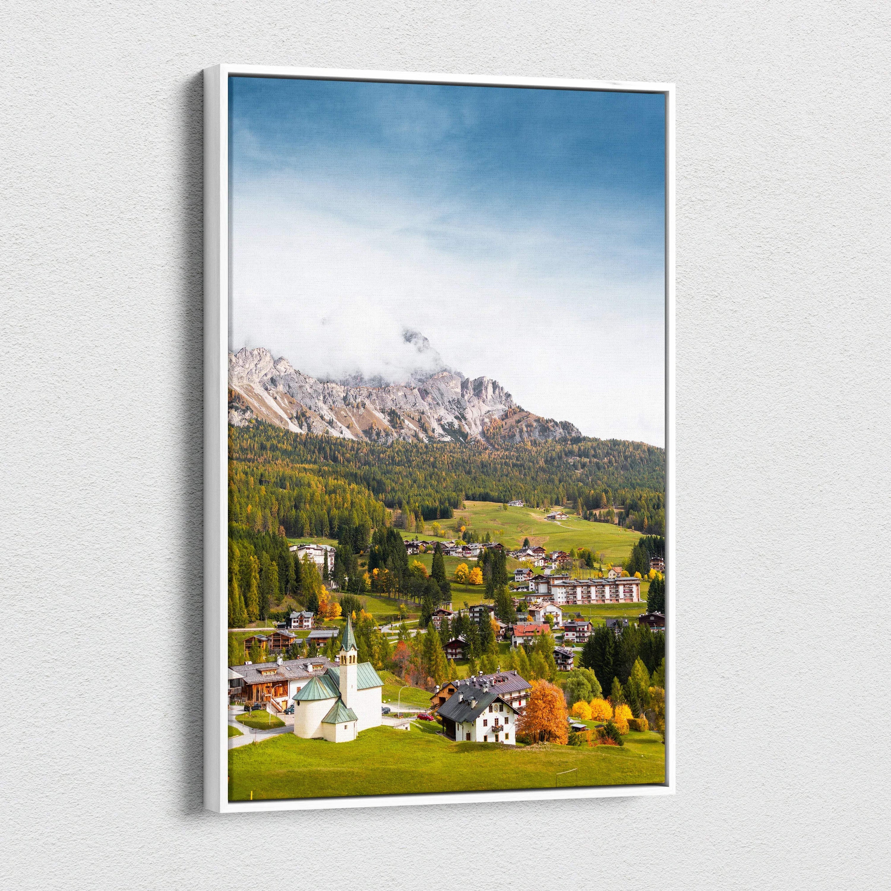 Vertical canvas wall art of a vibrant mountain village with autumn trees and clear blue sky.