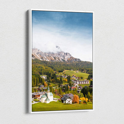 Vertical canvas wall art of a vibrant mountain village with autumn trees and clear blue sky.