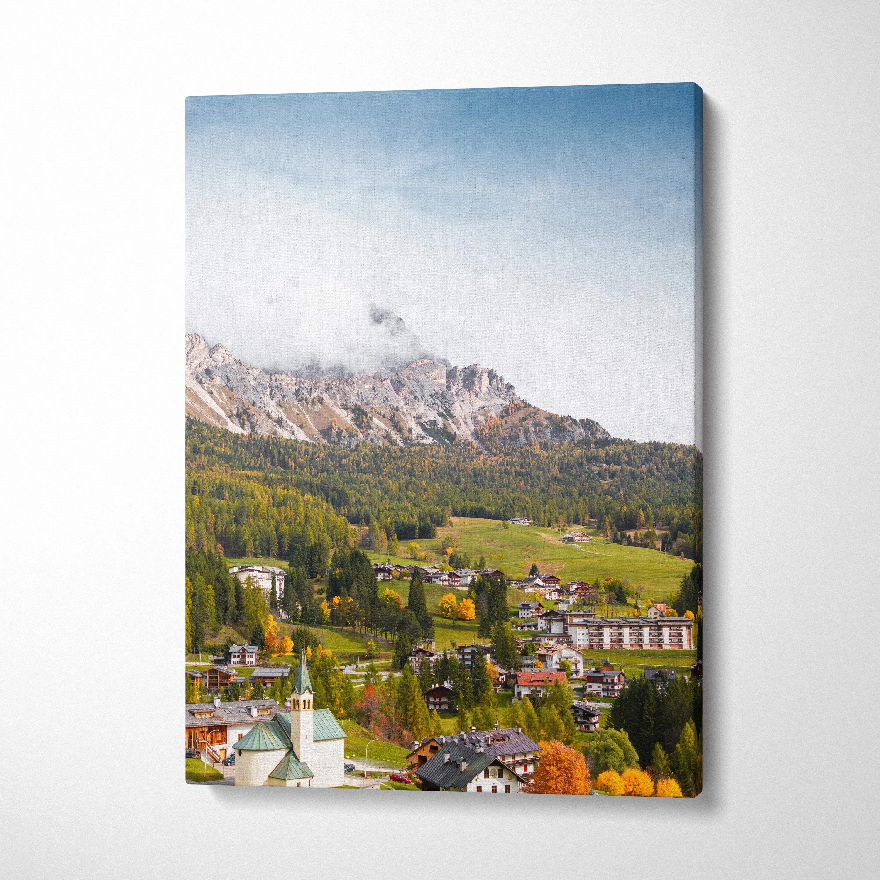 Vertical canvas wall art featuring stunning mountain landscape with village and autumn foliage.