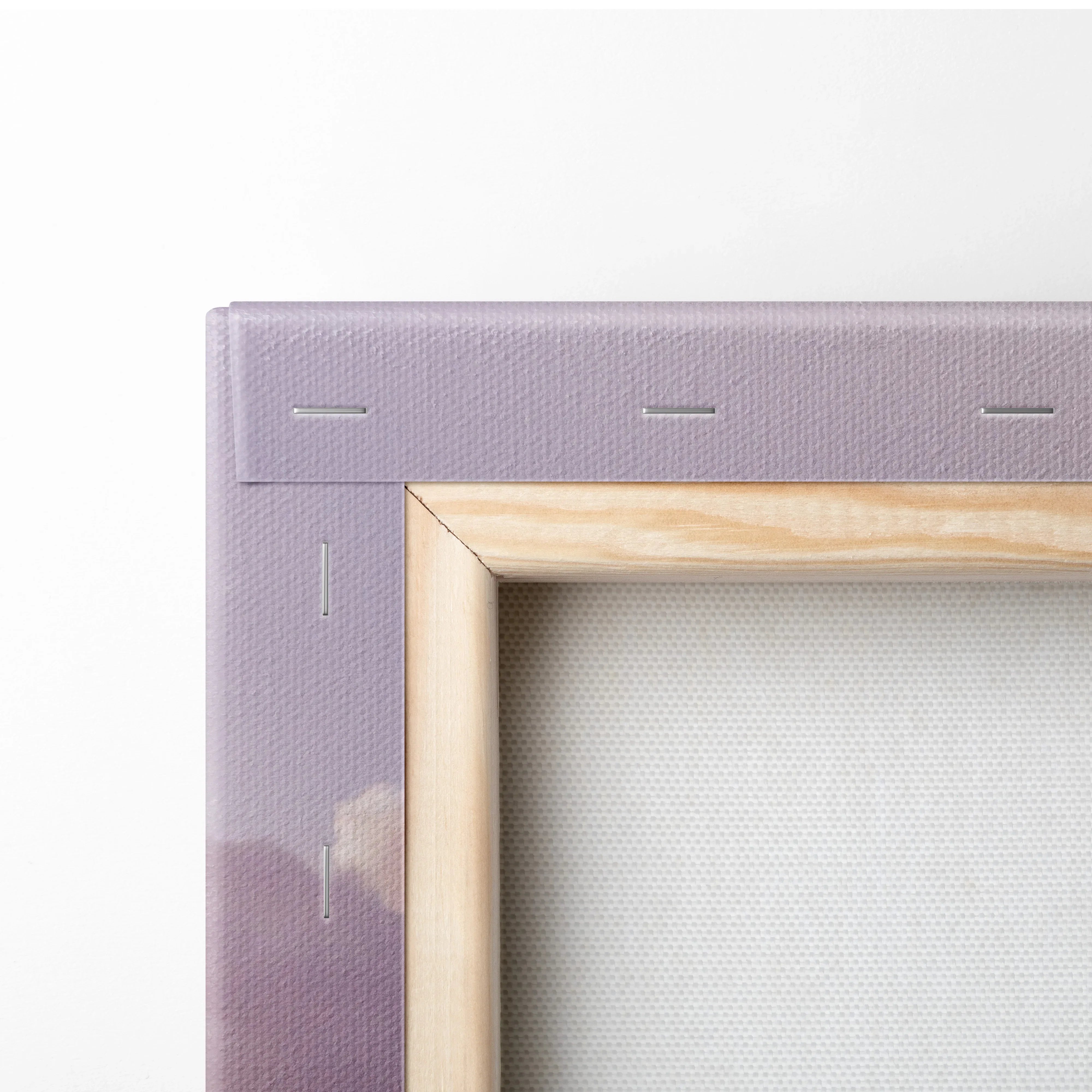 Close-up of wooden frame and purple stretched canvas corner for vertical wall art print.