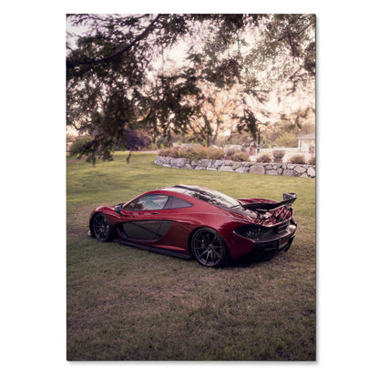 Red McLaren P1 parked on grass under trees during sunset poster wall art.