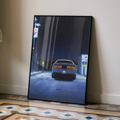 Dodge Challenger rear view poster wall art with vintage gas station night scene in black frame.
