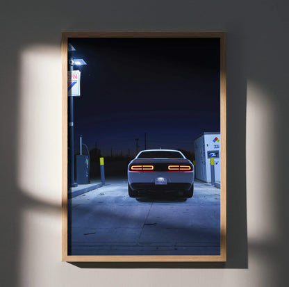 Dodge Challenger rear view at gas station at night poster wall art in wooden frame.