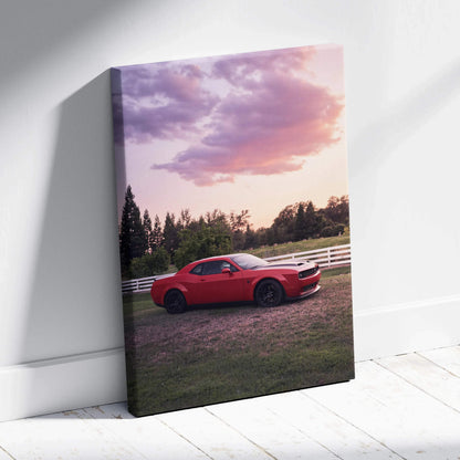 Red Dodge Challenger Hellcat parked on grass at sunset with vibrant sky, vertical canvas wall art.