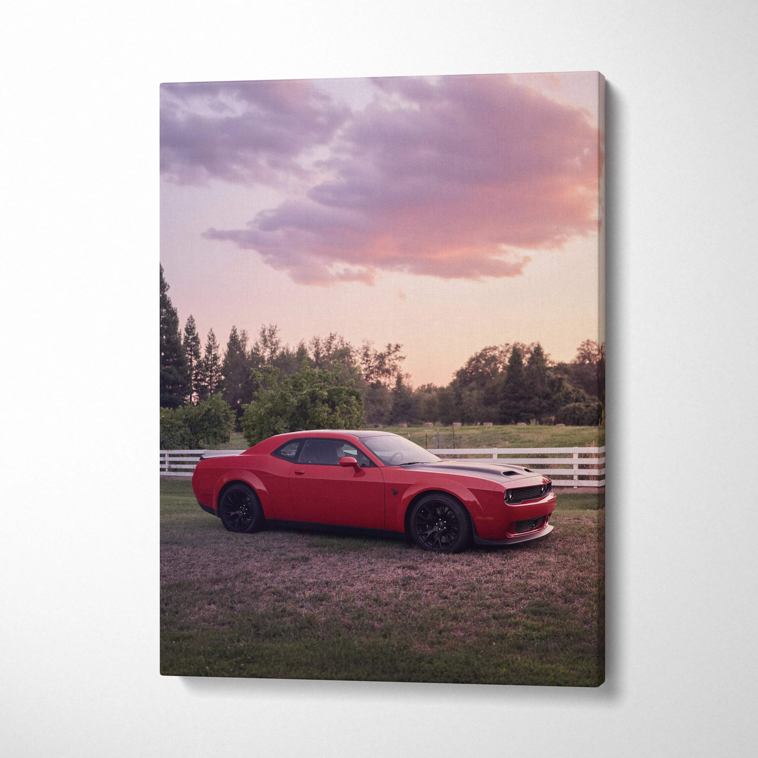 Red Dodge Challenger Hellcat parked on grass with sunset sky canvas wall art.