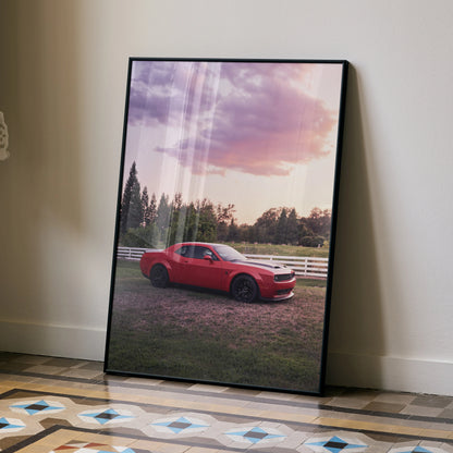 Dodge Challenger Hellcat in red parked on grass at sunset framed poster wall art.