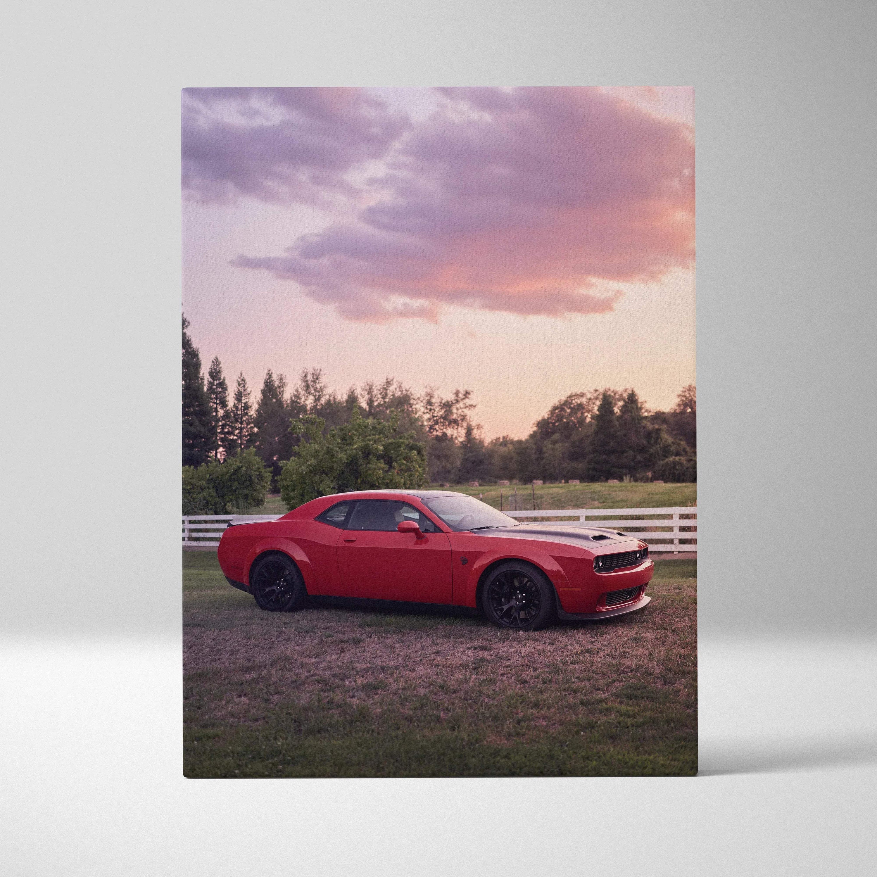 Red Dodge Challenger Hellcat parked on grass with sunset sky canvas wall art.