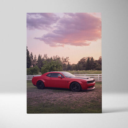 Red Dodge Challenger Hellcat parked on grass with sunset sky canvas wall art.
