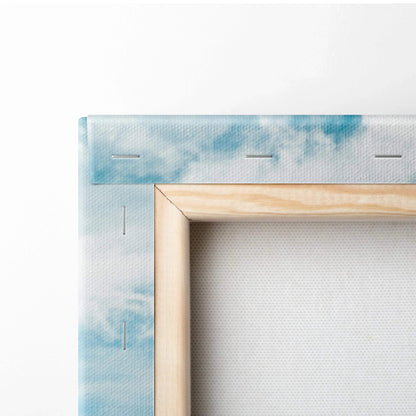 Close-up of stretcher bars and staples on canvas art showing wood frame with sky-blue printed fabric on the back of wall art .