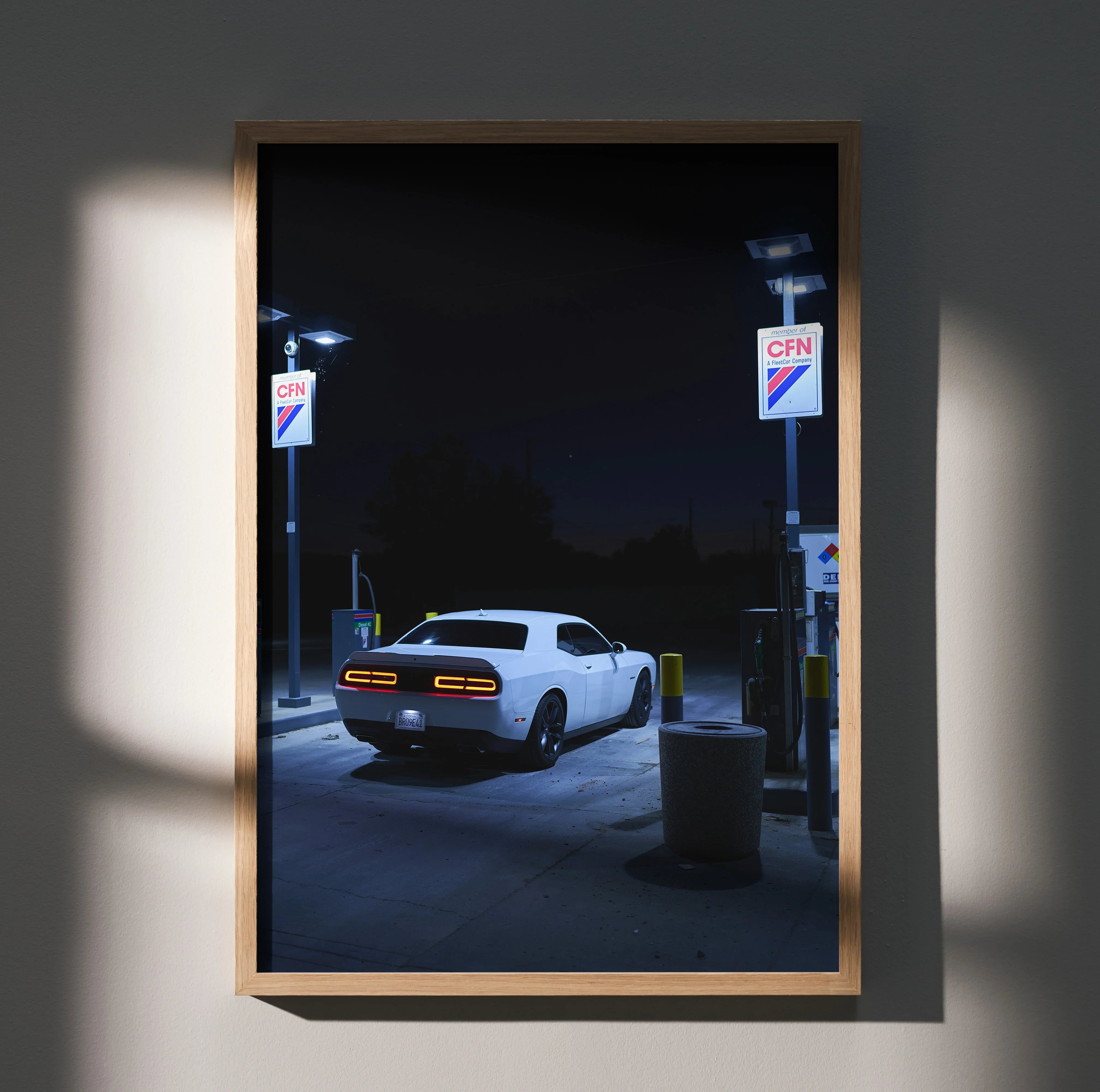 Dodge Challenger white muscle car at gas station night poster wall art in wooden frame.
