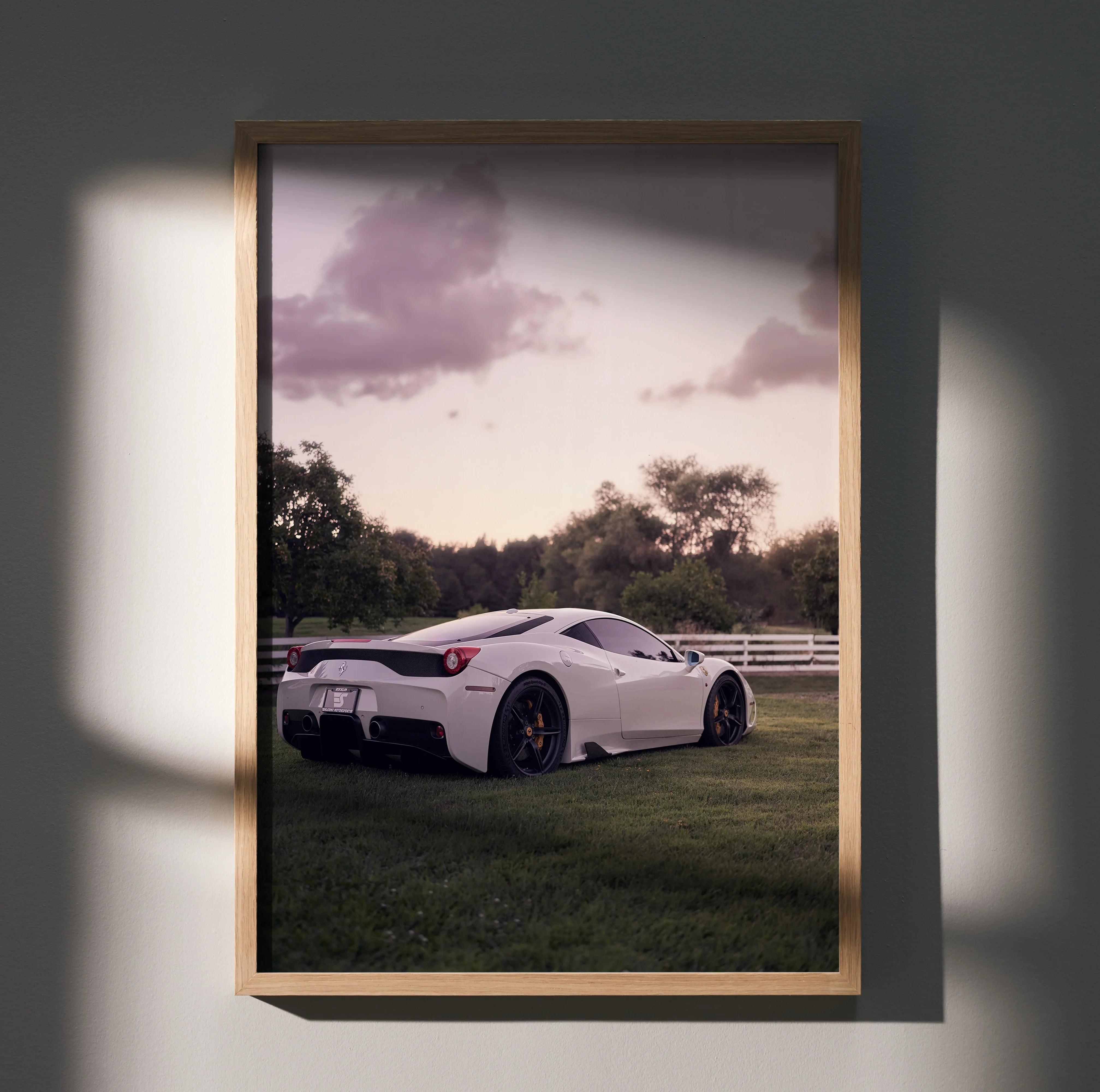 White Ferrari 458 Italia parked on grass with pink sky in framed wall art poster.