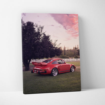 Red Porsche 911 Turbo Slant-Nose parked on grass under pink sunset sky canvas wall art.