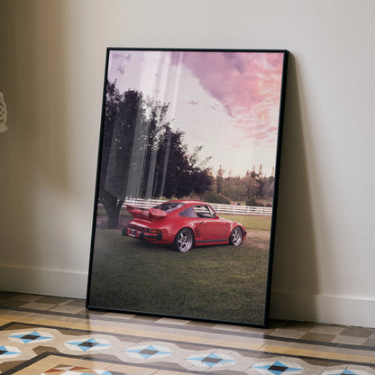 Red Porsche 911 Turbo Slant-Nose poster wall art with sunset sky in black frame.