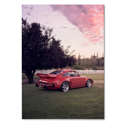 Red Porsche 911 Turbo Slant-Nose parked on grass with sunset sky Poster Wall Art.