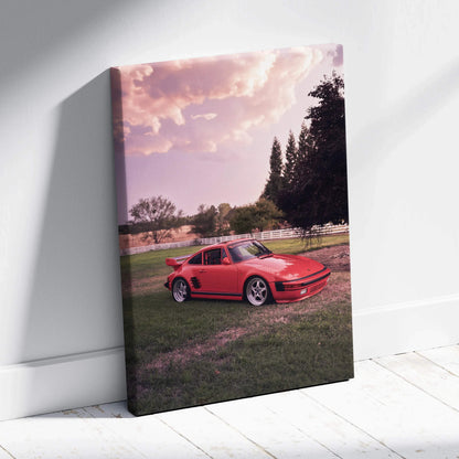 Red Porsche 911 Turbo Slant-Nose parked on grass at sunset on vertical canvas wall art.
