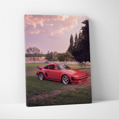 Red Porsche 911 Turbo Slant-Nose on green grass with sunset sky canvas wall art.