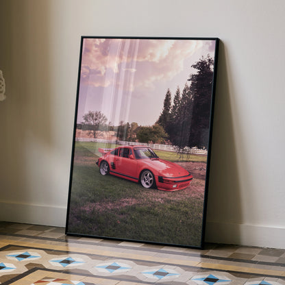 Porsche 911 Turbo Slant-Nose poster with red car at sunset on grassy field wall art.