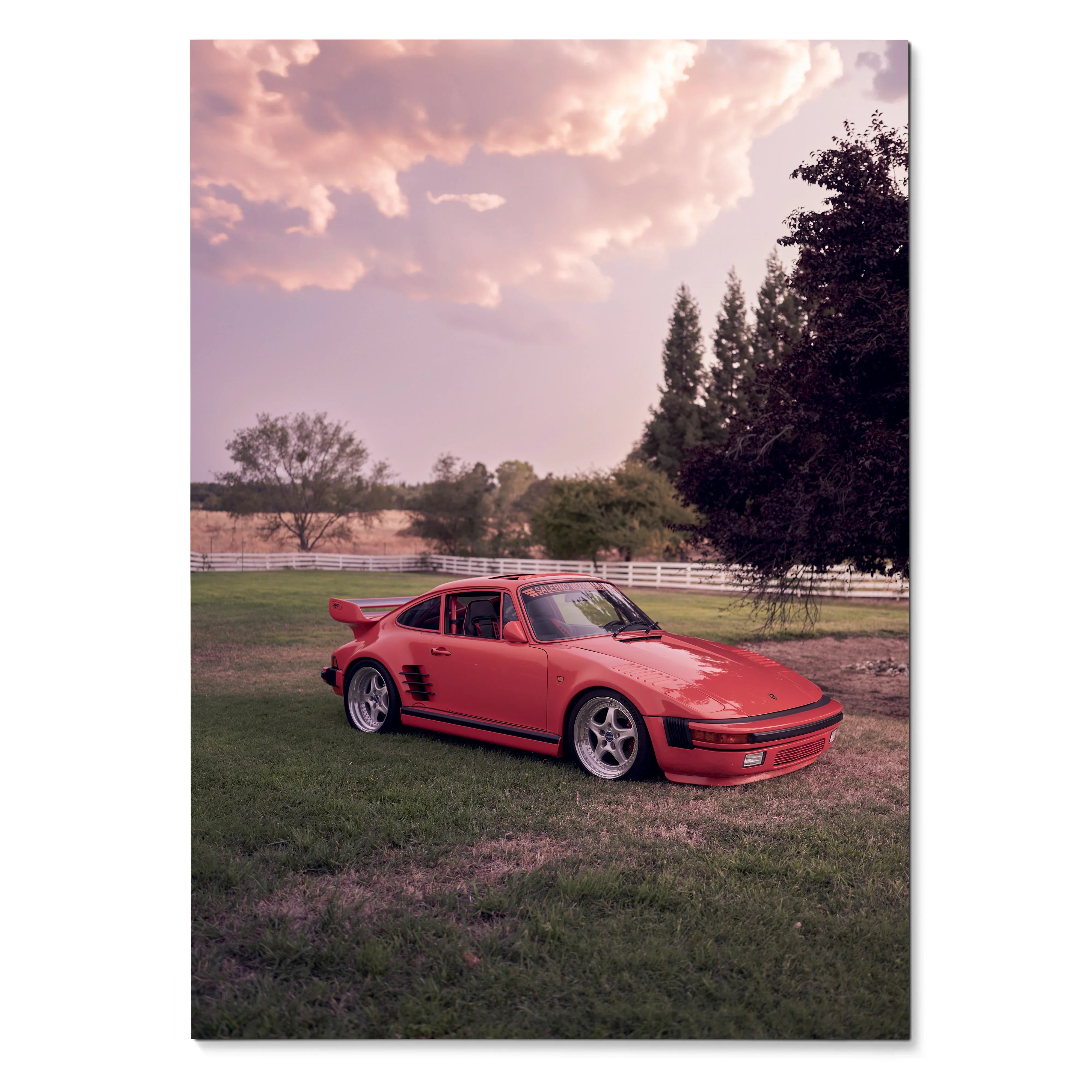 Red Porsche 911 Turbo Slant-Nose parked on grass under a pink sunset sky poster wall art.