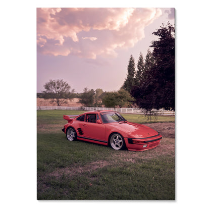 Red Porsche 911 Turbo Slant-Nose parked on grass under a pink sunset sky poster wall art.