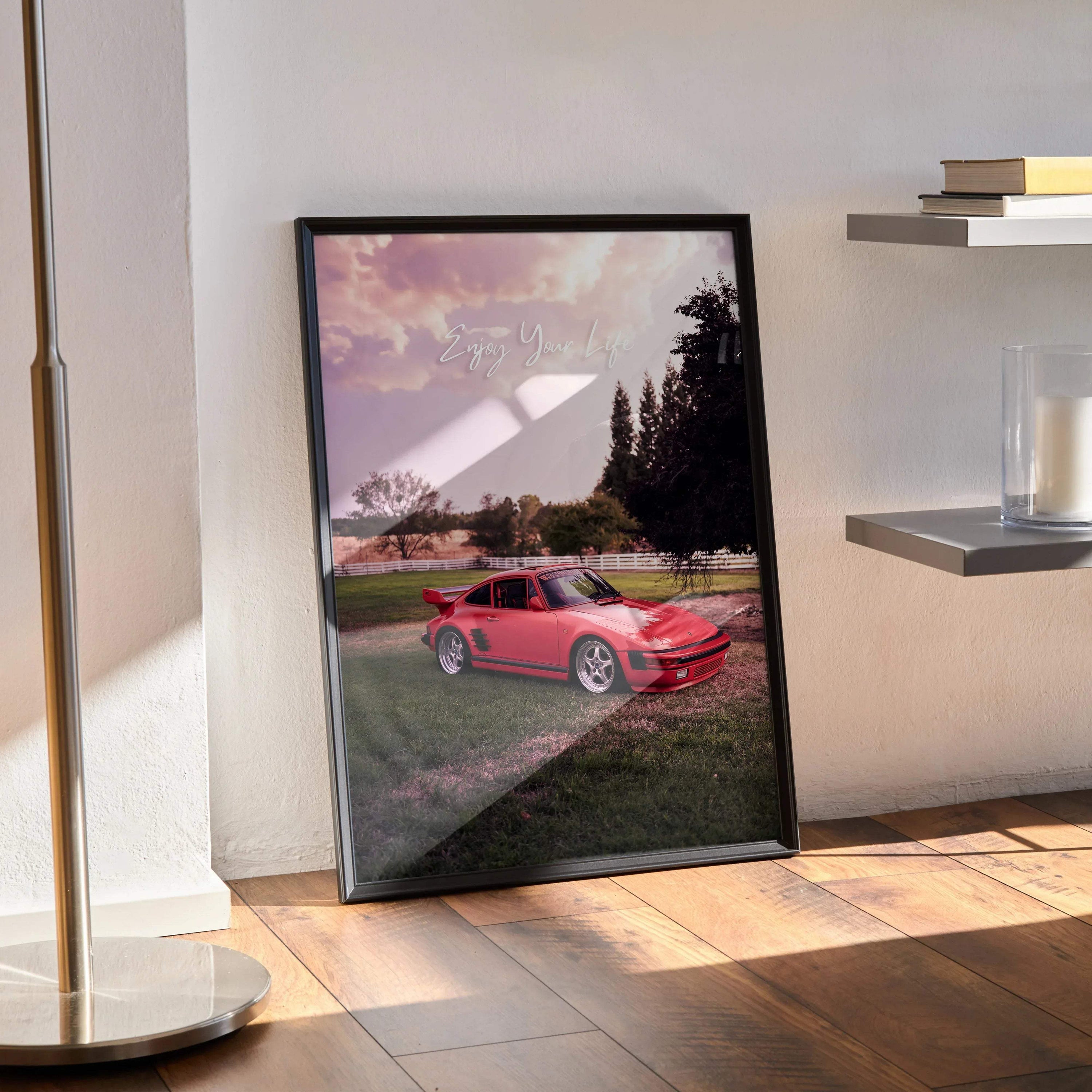 Motivational poster featuring red Porsche 911 Turbo Slant-Nose parked on grass with scenic forest background, framed wall.
