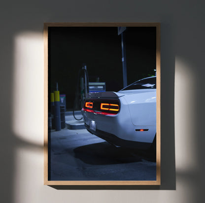 Dodge Challenger rear view with illuminated taillights at night poster wall art in wooden frame.