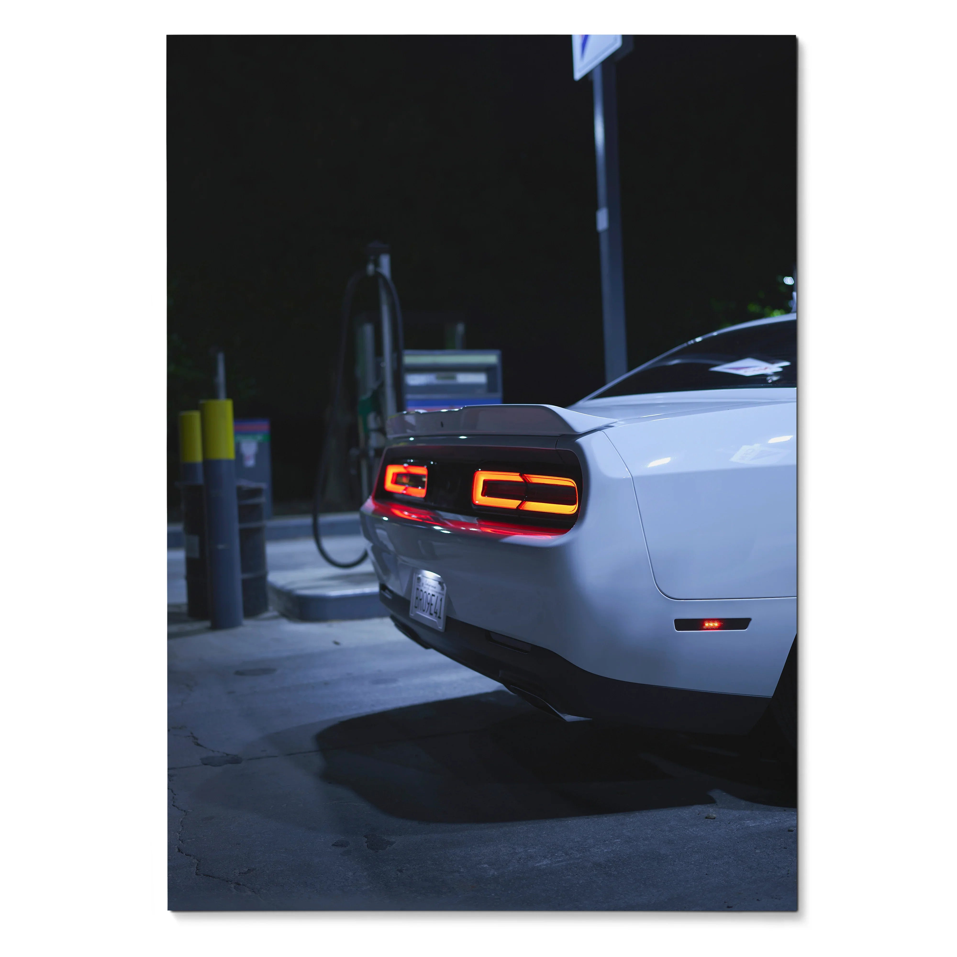White Dodge Challenger rear with illuminated taillights at night poster wall art.