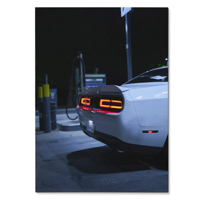 White Dodge Challenger rear with illuminated taillights at night poster wall art.