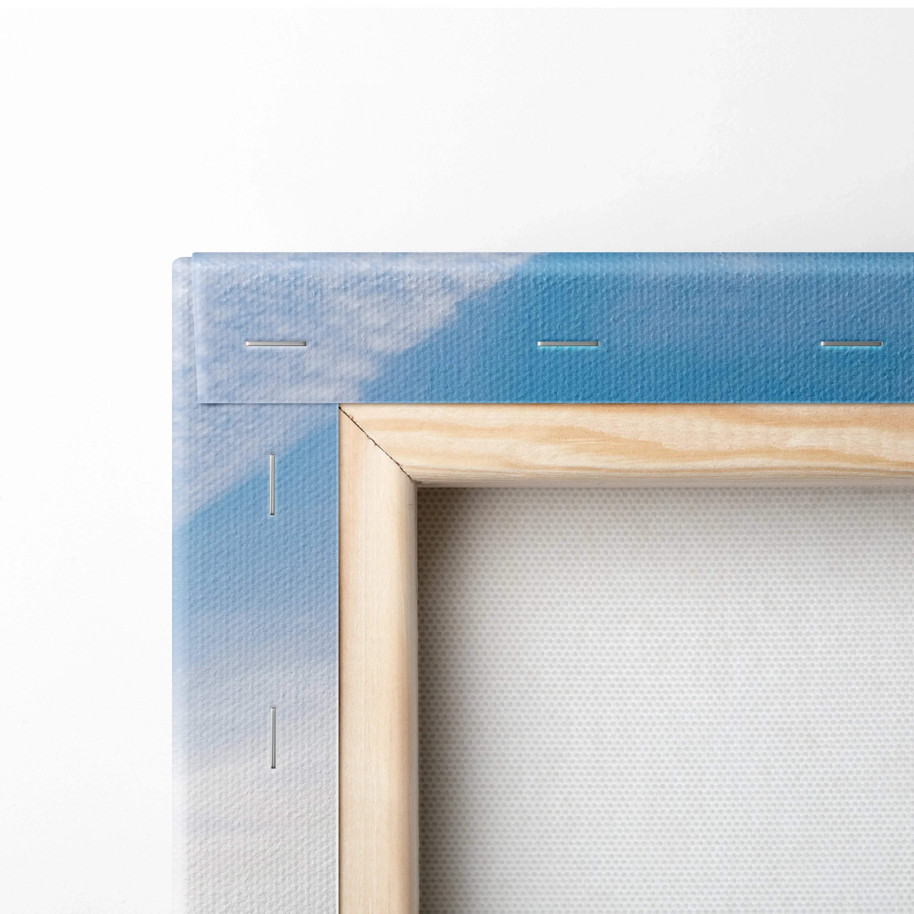 Close-up of wooden frame and stapled canvas back showing blue sky detail in wall art canvas print.