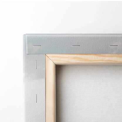 Close-up of stretched beige canvas over wooden frame with visible staples on back corner.