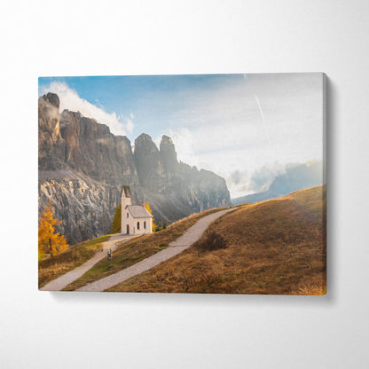 Canvas wall art of a small white chapel along a winding path with rugged mountains in the background.