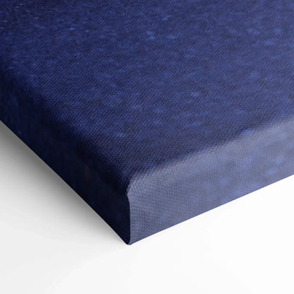 Close-up of deep blue textured canvas material for wall art wrapping a vertical canvas print corner.