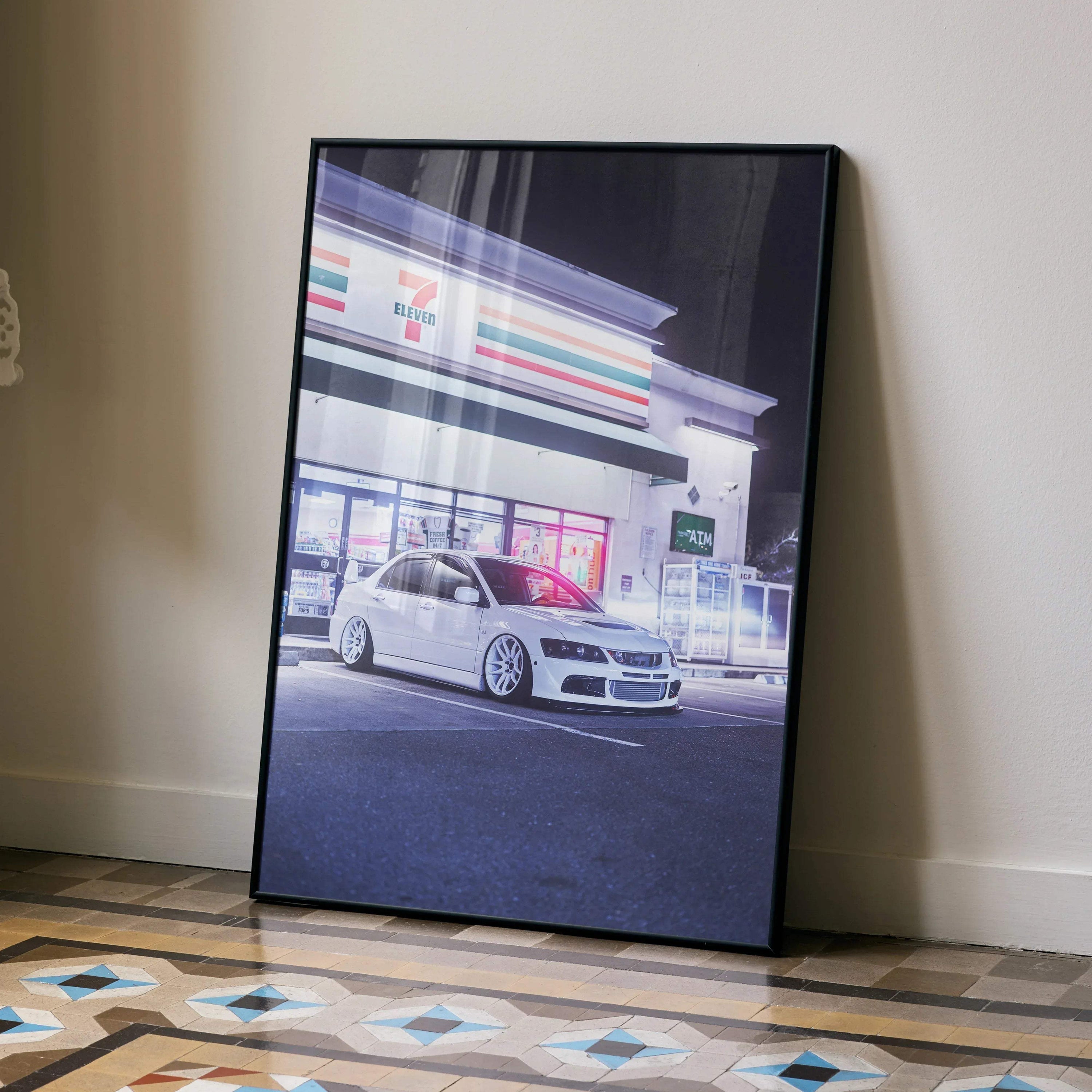 Mitsubishi Evo 8 poster featuring high-resolution car art in white, framed wall art leaning against beige wall.