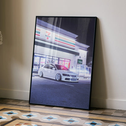 Mitsubishi Evo 8 poster featuring high-resolution car art in white, framed wall art leaning against beige wall.