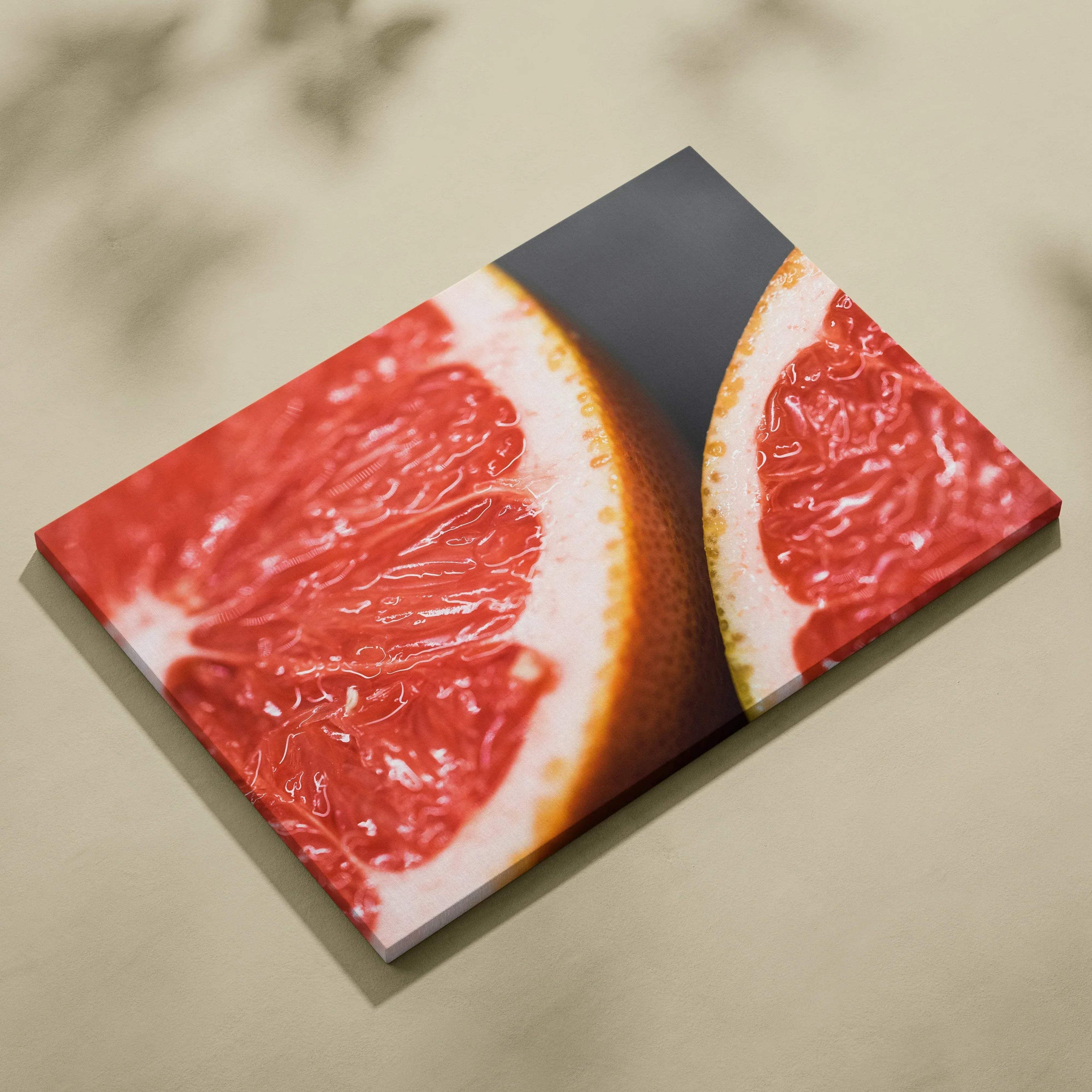 Vibrant grapefruit close-up on canvas wall art with modern decor style.