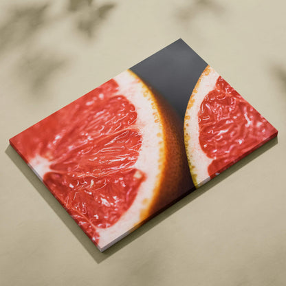 Vibrant grapefruit close-up on canvas wall art with modern decor style.