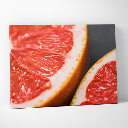 Vibrant grapefruit close-up canvas wall art with rich red and orange tones for modern decor.
