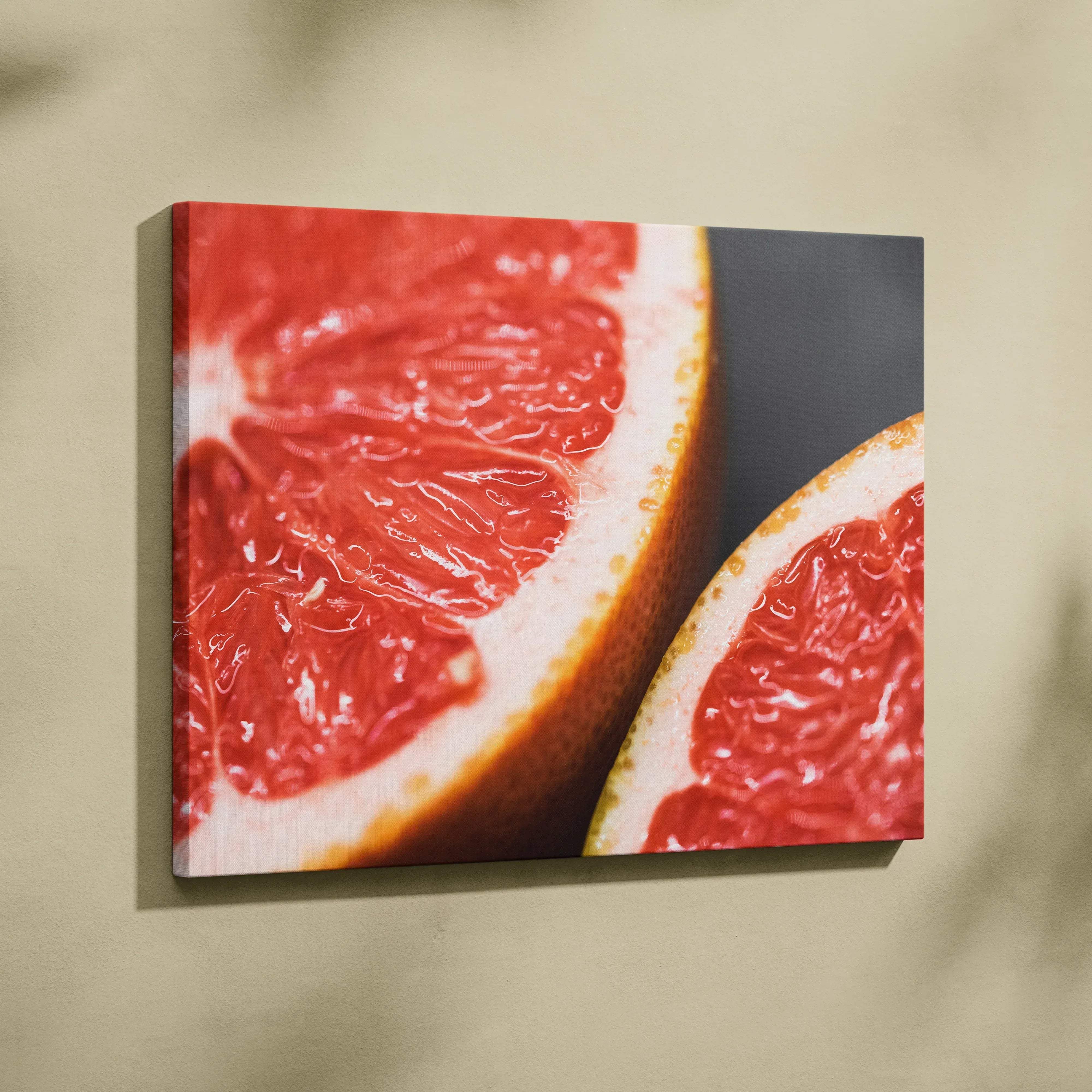 A vibrant red grapefruit canvas print with glossy juicy segments and textured rind for bright modern home decor