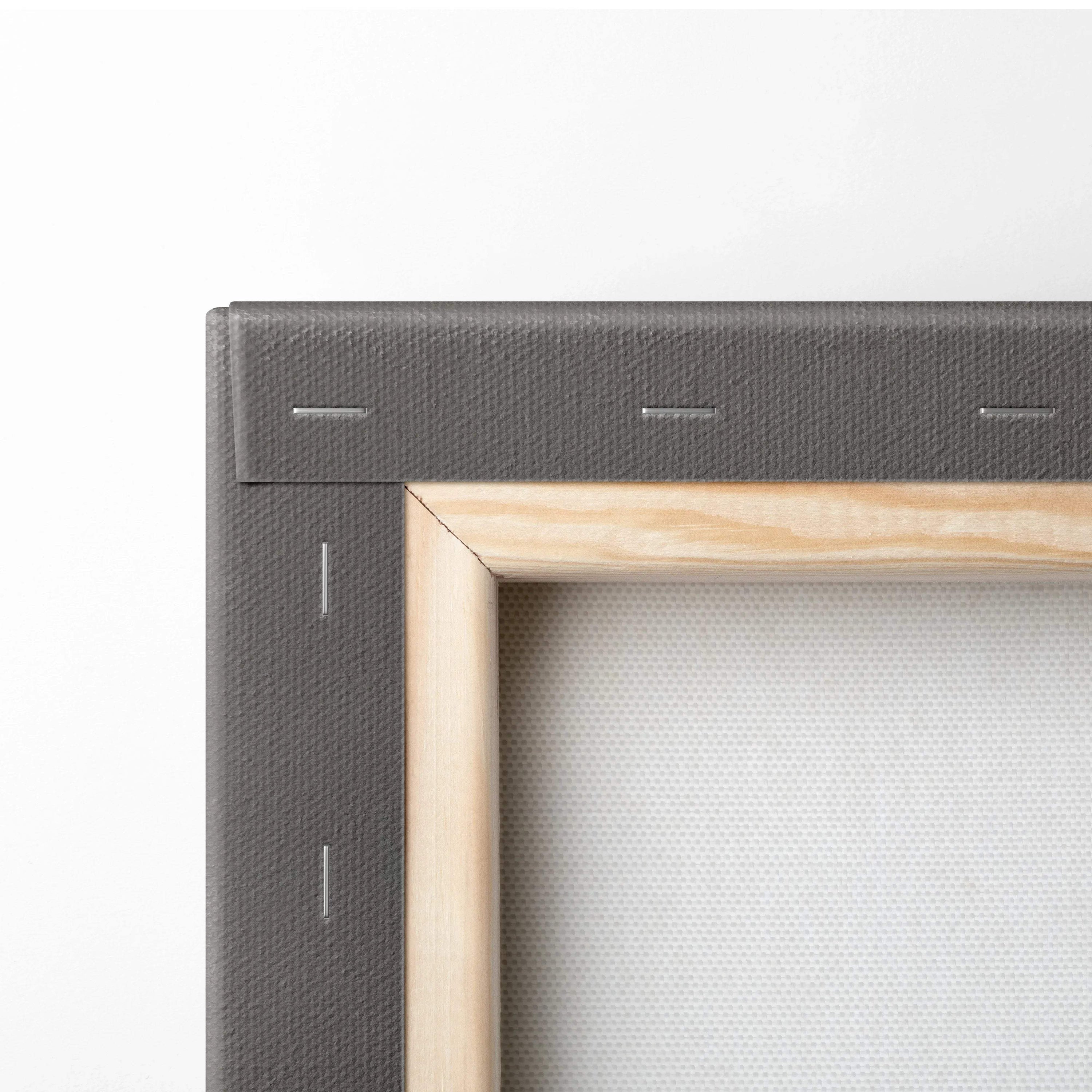 Close-up of wooden frame and stretched canvas corner with tight staples and textured white fabric.
