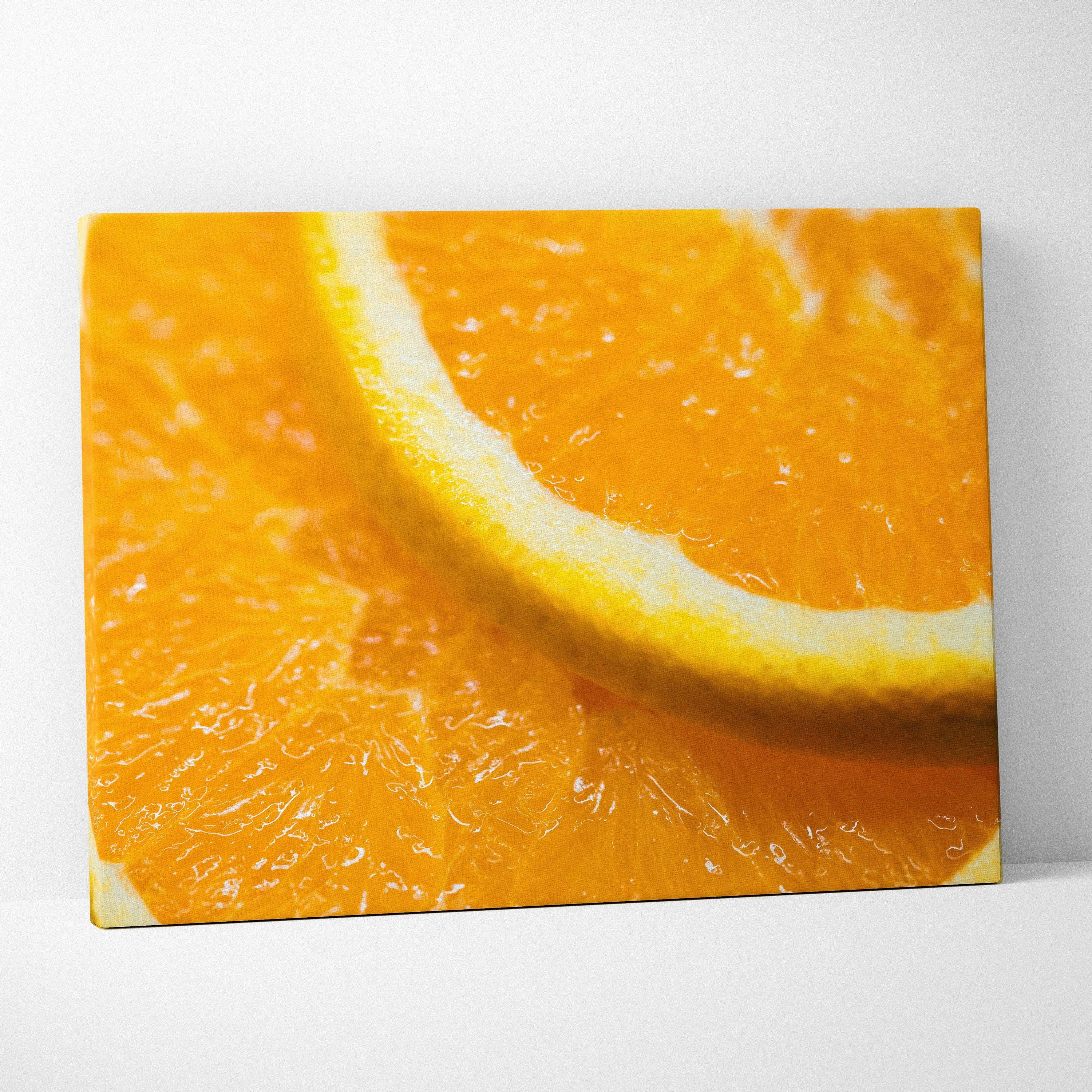 Close-up canvas wall art of vibrant orange slices with detailed texture and bright yellow rind.