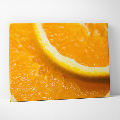 Close-up canvas wall art of vibrant orange slices with detailed texture and bright yellow rind.