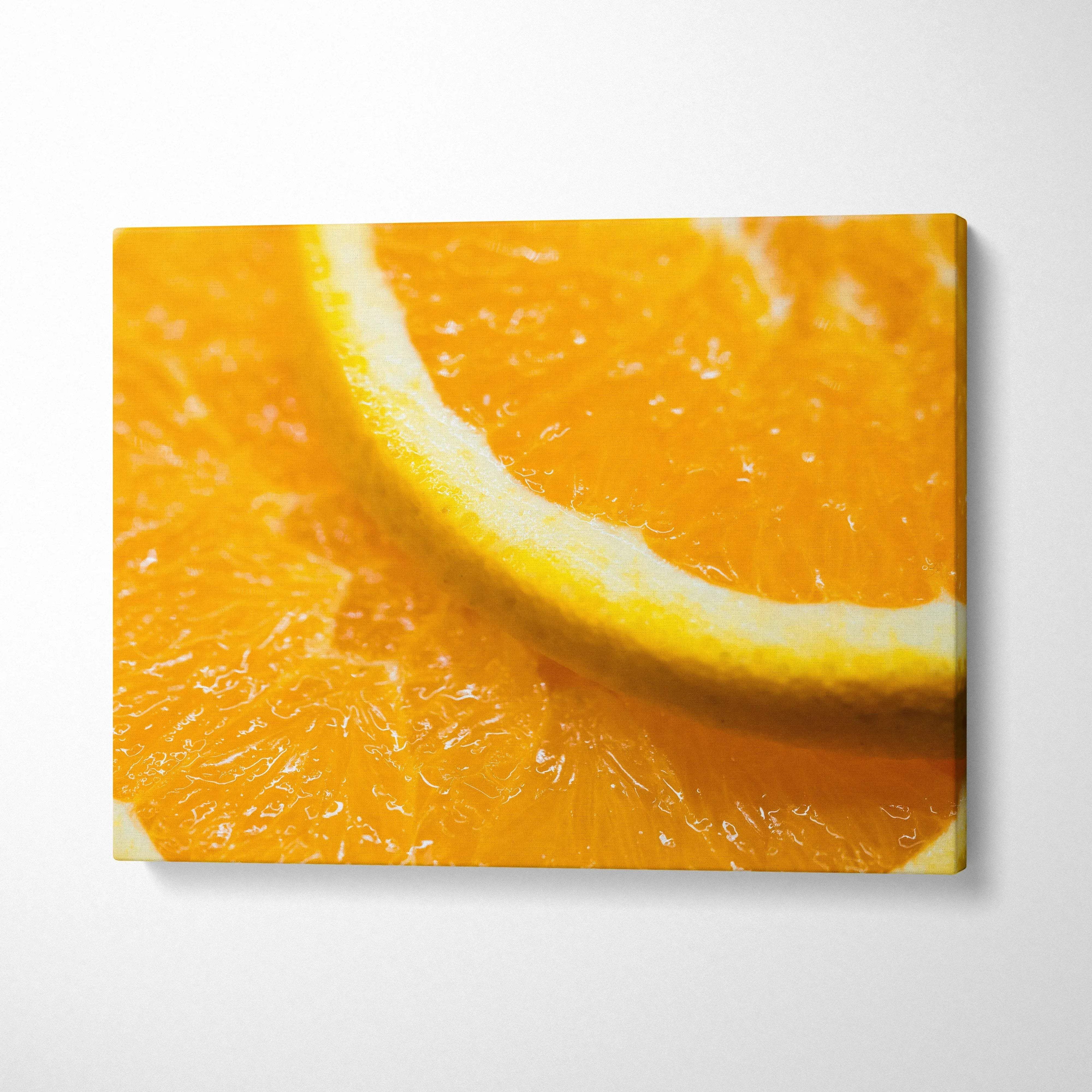 Bright orange slice close-up canvas wall art with vibrant colors for home decor.