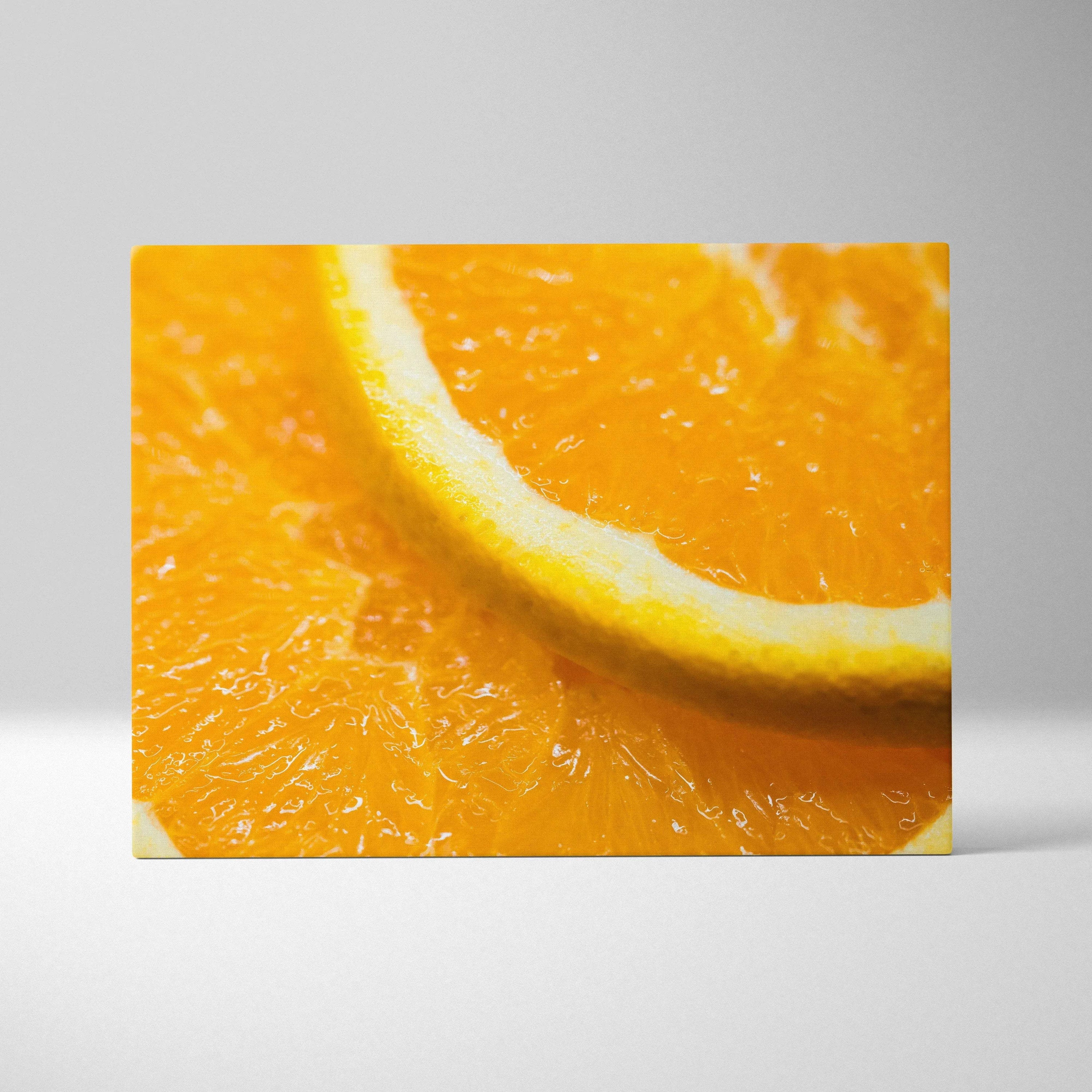 Close-up canvas wall art featuring a vibrant orange slice with bright yellow rind and juicy pulp texture.