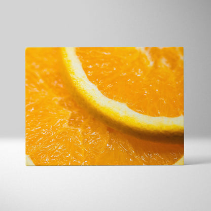 Close-up canvas wall art featuring a vibrant orange slice with bright yellow rind and juicy pulp texture.