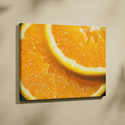 Canvas wall art featuring a vibrant close-up of juicy orange slices in bright, warm tones.
