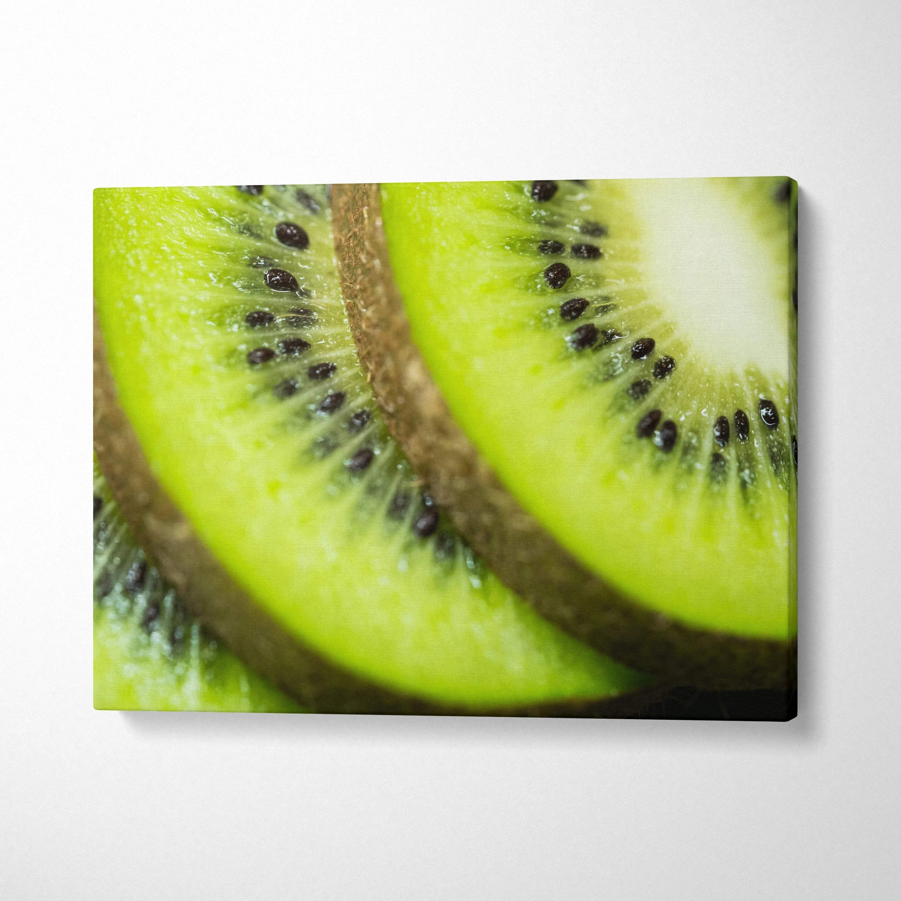 High-resolution canvas wall art featuring a close-up of ripe kiwi fruit slices with vibrant green and black seeds decor.