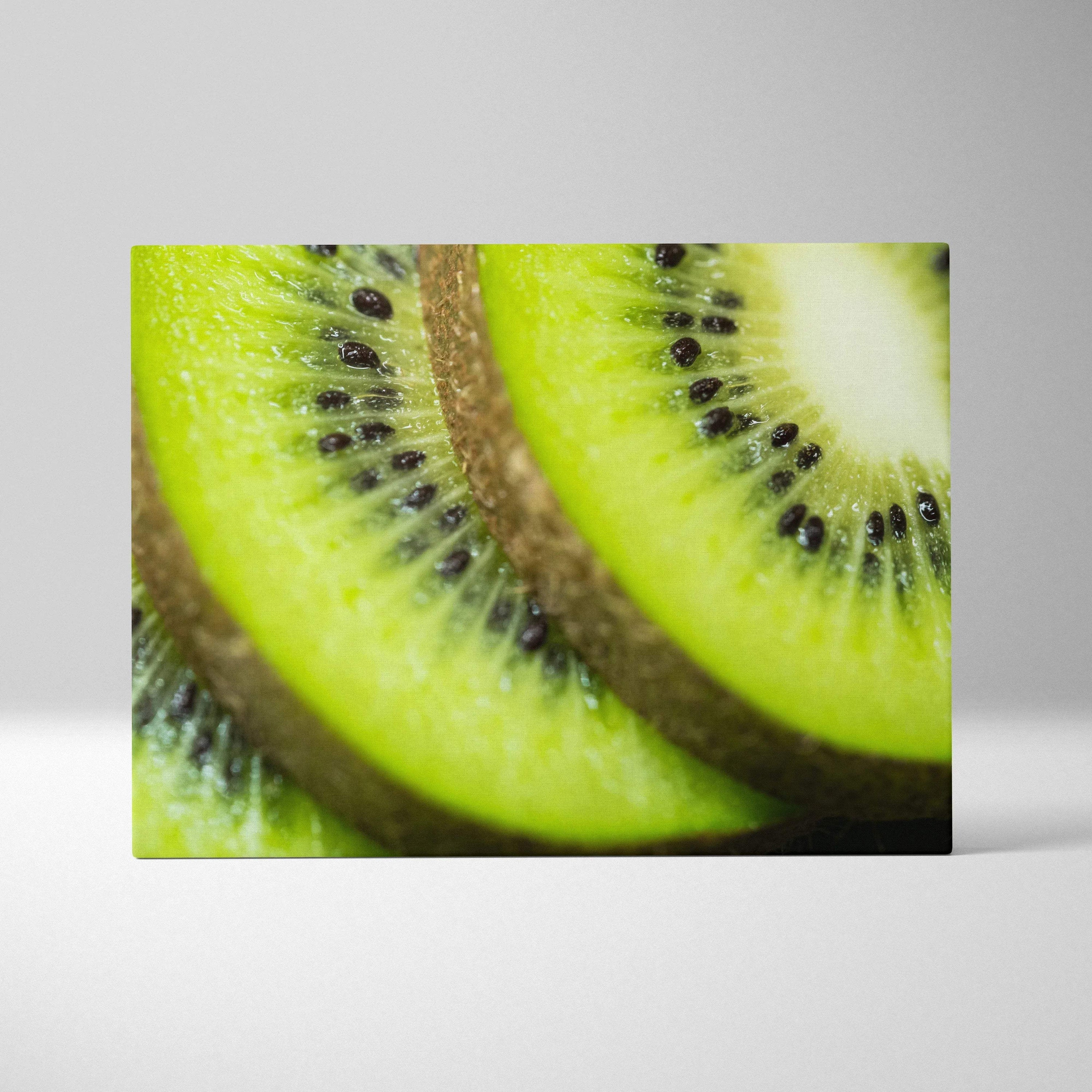High-resolution canvas wall art featuring a close-up of vibrant green ripe kiwi slices with detailed black seeds and brown.