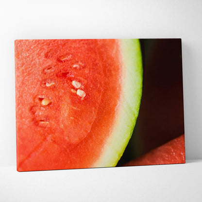 Close-up canvas wall art featuring a vibrant red watermelon slice with green rind and visible seeds on a dark background.